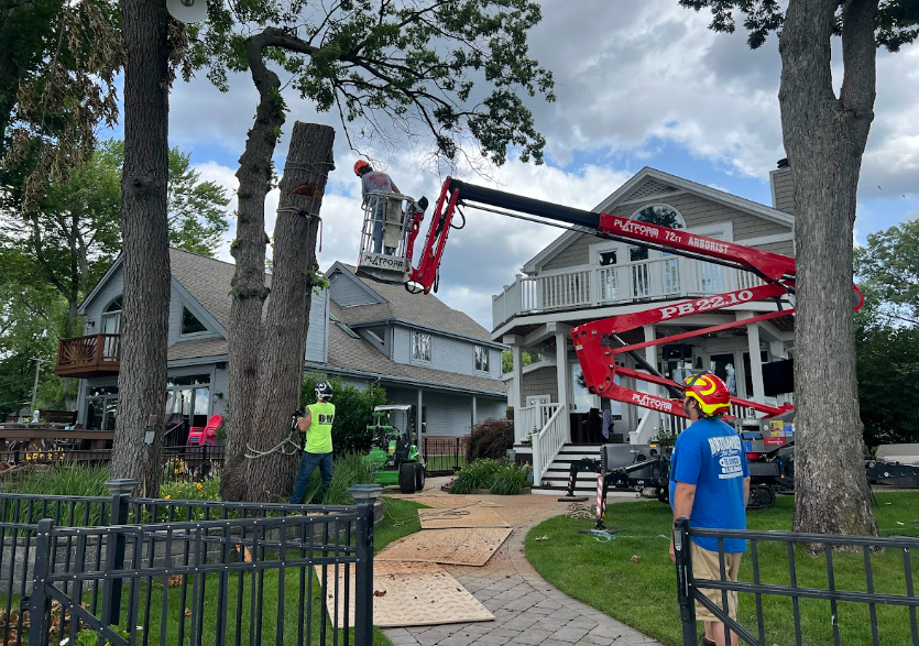 Professional tree service crew from Holtslander and Sons preparing equipment for residential tree work in Fenton Michigan